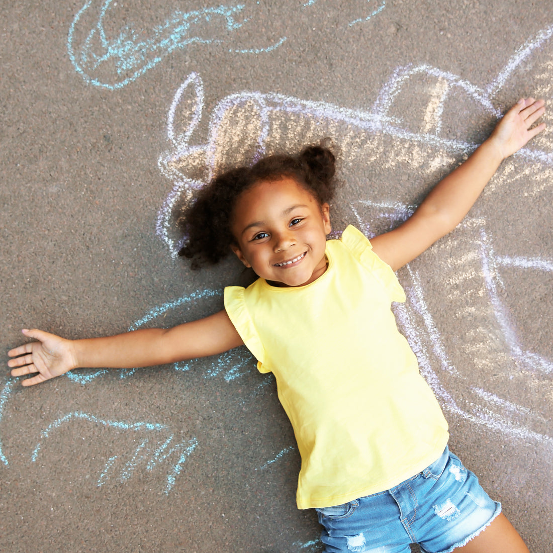 kid using sidewalk chalk